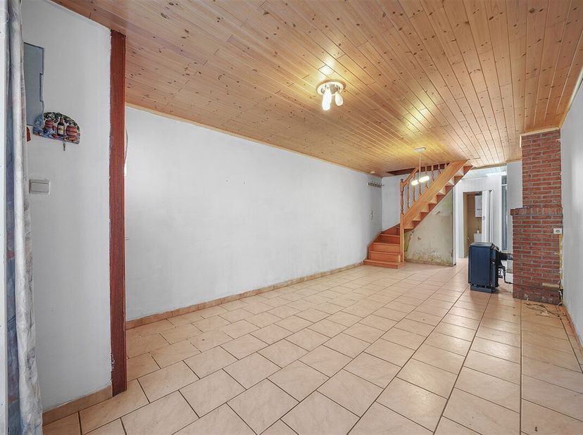 Stadswoning die volledig gerenoveerd moet worden, bestaande uit een woonkamer die uitkomt op een halfingerichte keuken, wc, douche, 2 slaapkamers en z