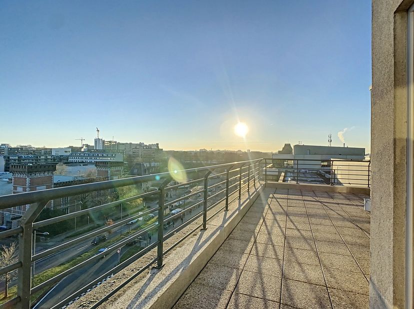 Victoire-Junot stelt u dit uitzonderlijke penthouse voor, ideaal gelegen tegenover de Arsenal, vlakbij het station van Etterbeek en de metro. Gelegen
