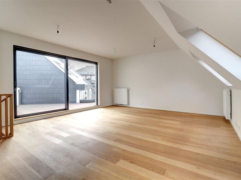 TRONE - Schitterend duplex penthouse van 92m² gelegen op de 3e en 4e verdieping van een luxe gebouw. Het bestaat uit een inkomhal met gastentoilet, 2