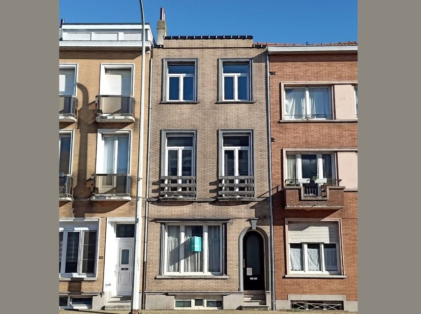 Centraal gelegen WONING met terras op enkele stappen van het station, centrum &amp; Zeedijk. Indeling: glvl.: inkomhal. De volledige gelijkvloerse verdiep