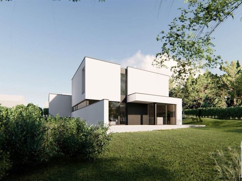 Splendide villa Q-Zen à construire sur un terrain de fond d&#039;une superficie de 11a25ca idéalement orienté dans un chemin privé. La villa offre: hall de
