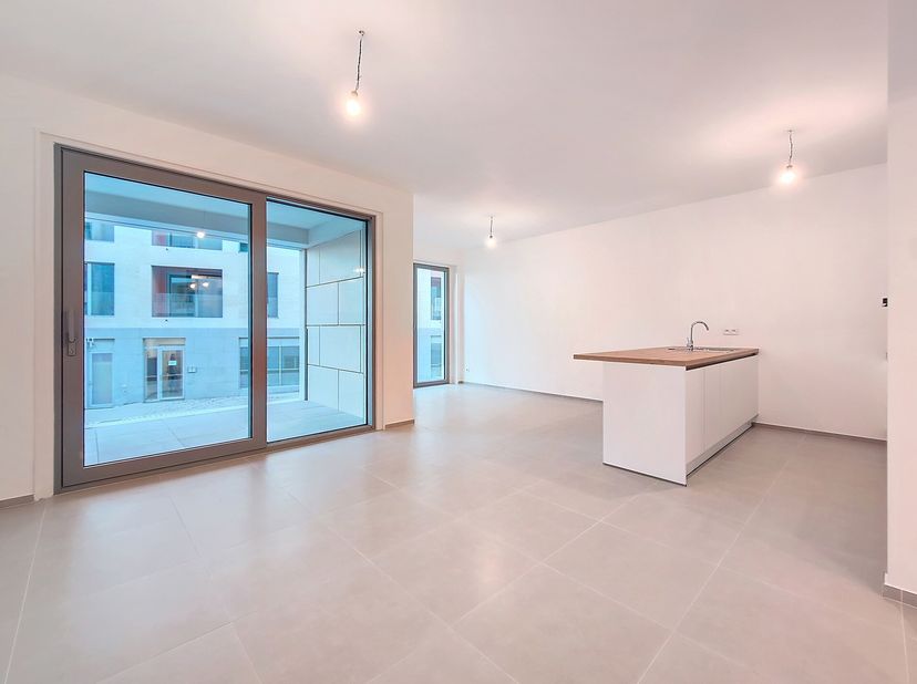 &quot;BELLECOUR&quot;, een uniek project in het hart van Braine-lAlleud. Ontdek dit lichte 2-slaapkamerappartement. Het omvat een inkomhal met vestiaire en gast