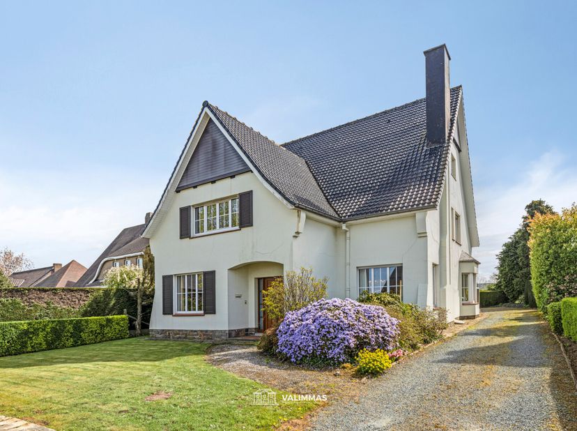 VALIMMAS verkoopt deze welgelegen klassieke villa met dubbele garage en tuin, georiënteerd naar het zuidoosten.   Het gelijkvloers omvat een inkomhal,