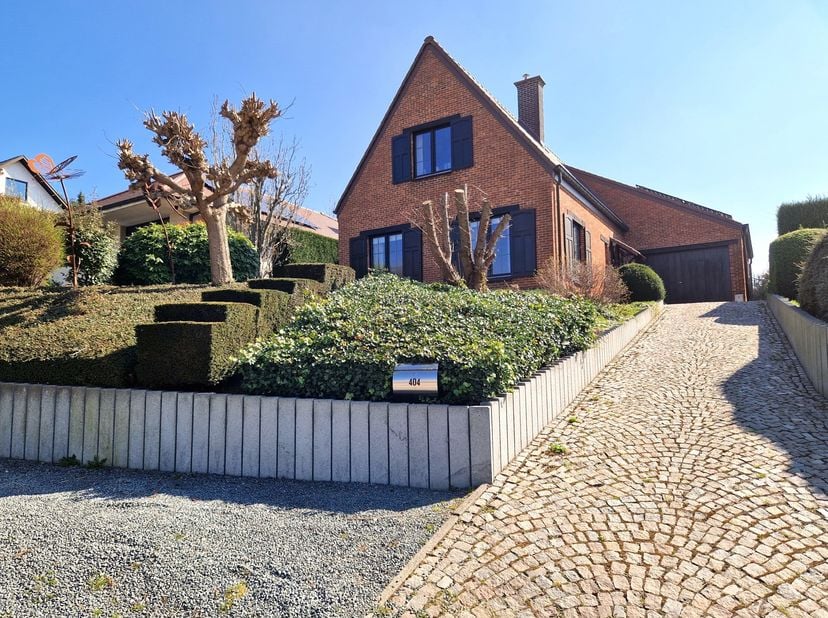 Deze karaktervolle villa, gelegen op een prachtig perceel van 9a 35ca, combineert charme, ruimte en een schitterende tuin met een ruime garage/multifu