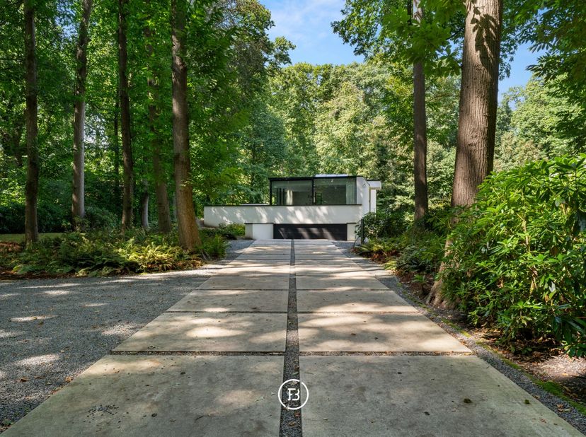 Cette villa moderne construite en 2018 est discrètement implantée sur un beau terrain de 2.461 m². La maison et le jardin sont situés en retrait de la