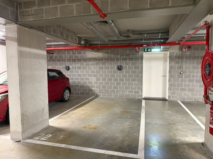 In de ondergrondse verdieping (niveau -1) van een recent appartementsgebouw bevindt zich deze vlot toegankelijke autostaanplaats met laadpunt.  De ond