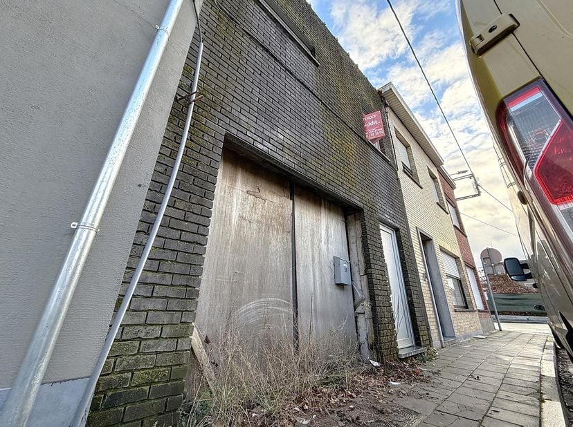 TE RENOVEREN EN AF TE WERKEN WONING -<br />
<br />
Centraal gelegen.<br />
Bestaande uit:<br />
- gelijkvloers: hal, garage, ruimte voor woonkamer en