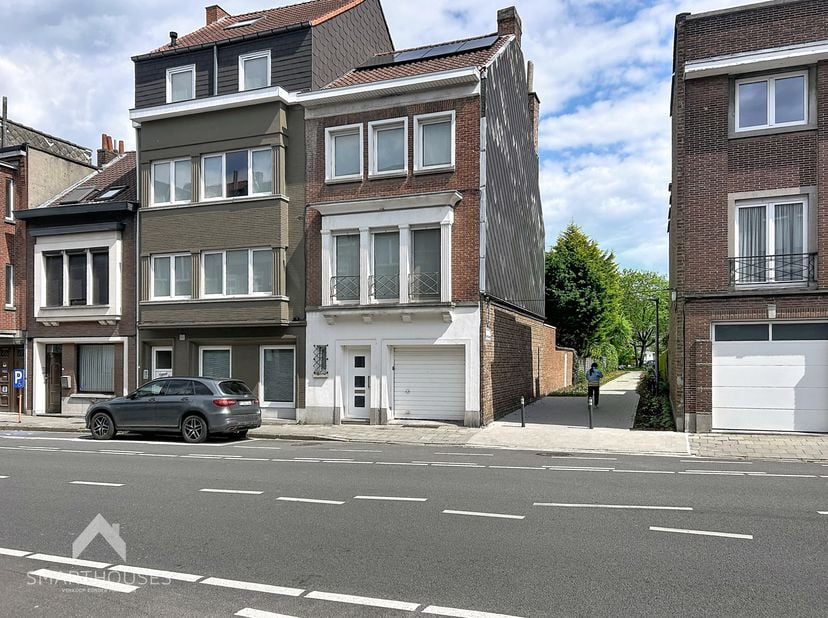 Centraal gelegen halfopen bebouwing op wandelafstand van allerlei faciliteiten bestaande uit een inkomhal met gastentoilet, garage met sectionale poor