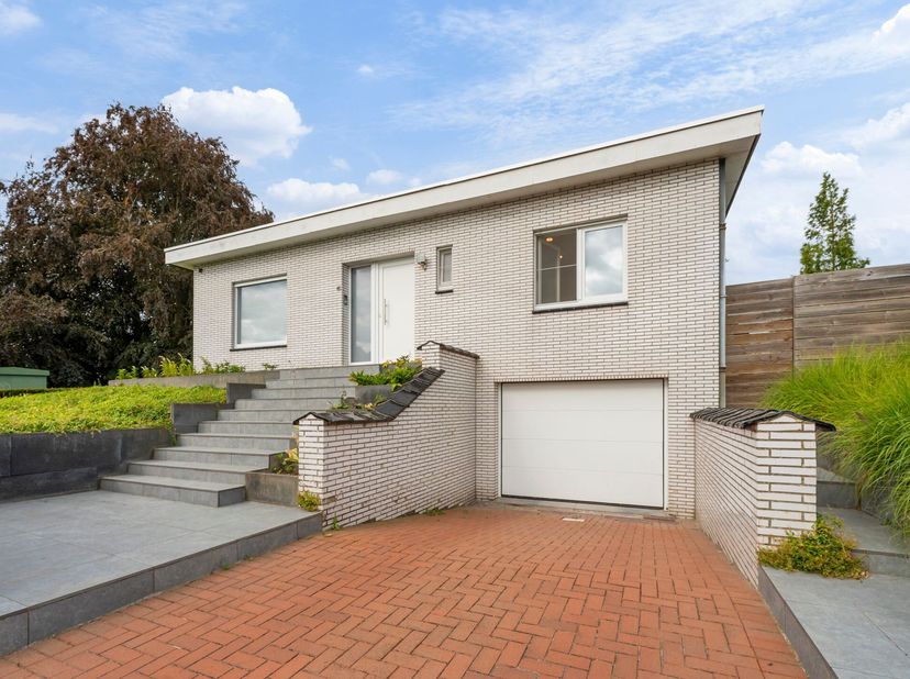 Volledig onderkelderde bungalow in rustige wijk te koop in Wevelgem<br />
Je betreedt de woning via de inkomhal met gastentoilet. Vervolgens kom je in