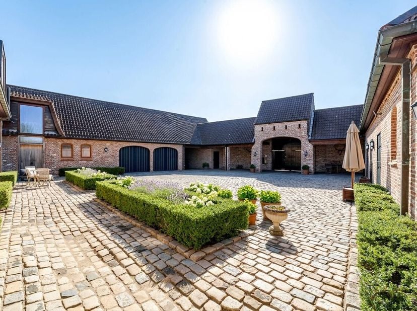 Espace pour vivre, lumière pour sépanouir et liberté totale pour lhomme et le cheval. Cette ferme carrée pleine de caractère à Oosterzele forme un dom