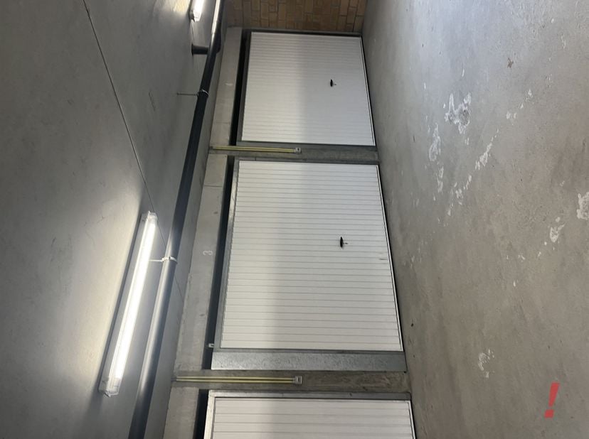 Gesloten garagebox op halve verdieping ondergronds bereikbaar via lichte helling in het gebouw.<br />
Vooraan is een centrale sectionale poort. Autom