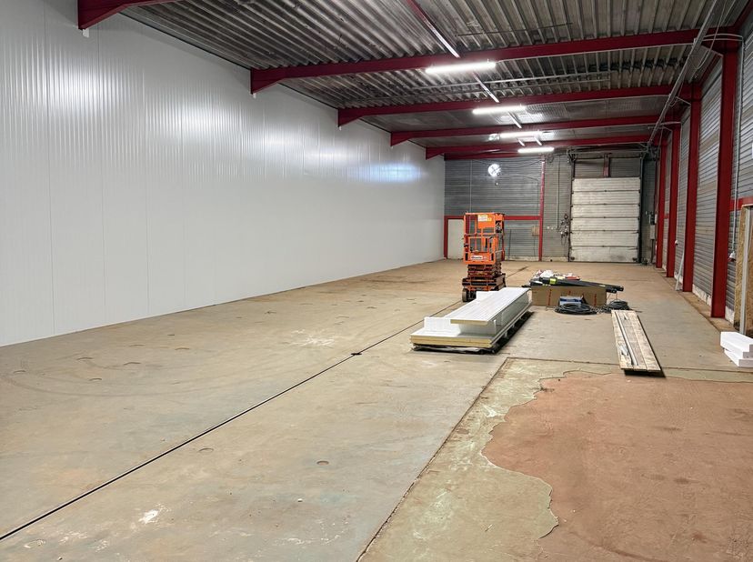 Vrije hoogte: +/- 5,2m<br />
1 elektrische sectionaalpoort (3x4m)<br />
1 toegangsdeur<br />
Betonvloer<br />
150kWh elektriciteit voorzien in de huur