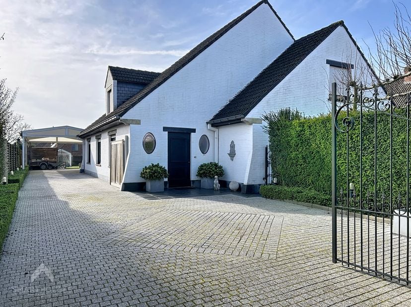 Instapklare villa op een centrale locatie bestaande uit een inkomhal met vestiaire en gastentoilet, ruime leefruimte met eet-en zithoek + houthaard, v