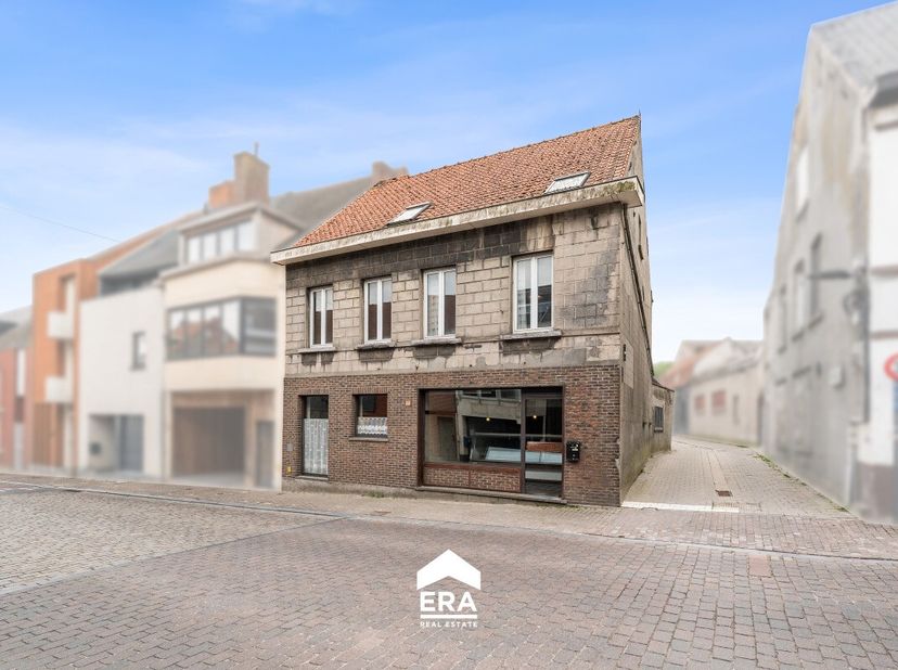 Op een ruim perceel van maar liefst 1.104 m² bevindt zich deze halfopen handelszaak met woonst, centraal gelegen in de dorpskern van Zomergem. Een eig