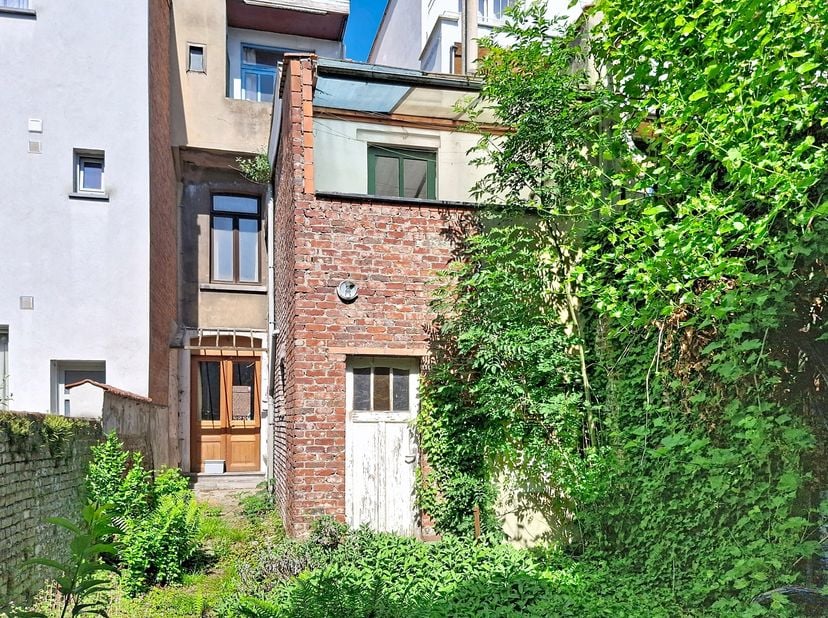 Te renoveren woning met veel potentieel, bestaande uit een inkomhal, ruime woonkamer met toegang tot de tuin en een keuken eveneens met toegang tot de