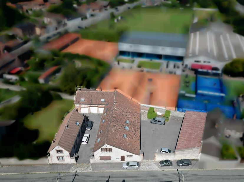 Vastgoedcomplex dicht bij het centrum van het dorp Vaulx en de snelweg, bestaande uit een huis, twee appartementen, een duplex, een polyvalente zaal e