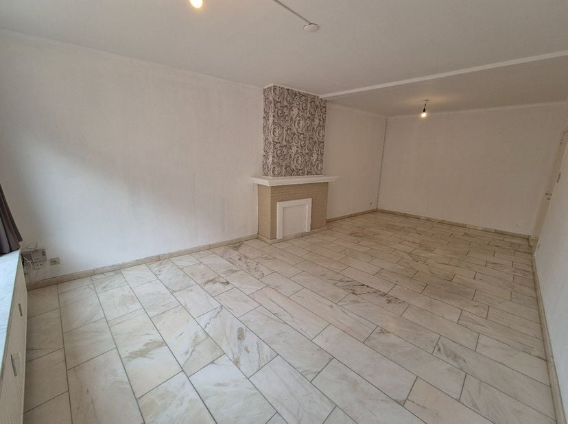 Dit gelijkvloers appartement op wandelafstand van het stadscentrum bestaat uit een ruime living, keuken met kasten, enkele afwasbak en dampkap, badkam
