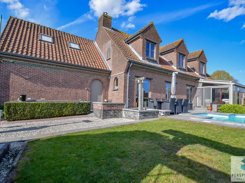 Klassevolle villa met handelsruimte, dubbele garage, grote tuin met zwembad, poolhouse en landelijk uitzicht op een perceel va 1.370 m². Rustig en lan