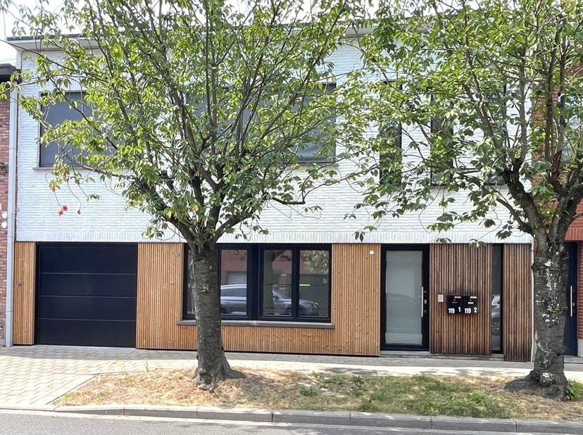 Dit ruime gelijkvloers appartement beschikt over een inkomhal met apart toilet, een zeer grote leefruimte met open volledig geïnstalleerde keuken en t