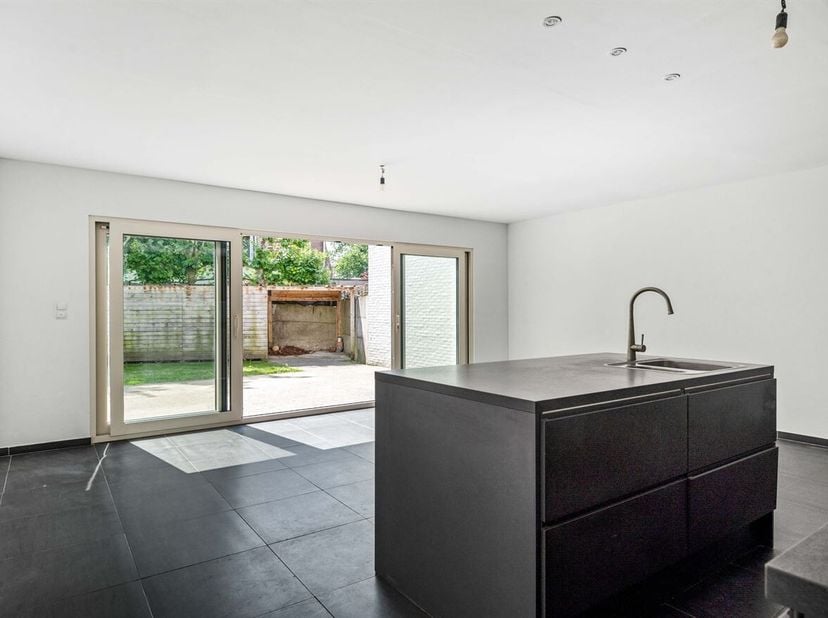 Gezinswoning met 2 slaapkamers (mogelijkheid tot 3) en tuin met carport<br />
Gelijkvloers<br />
Via de inkomhal betreedt u de woning. Aan de voorzijd