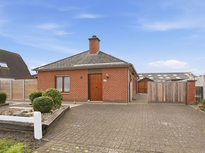 In een rustige woonomgeving in Jabbeke, met vlotte verbinding naar de E40, bevindt zich deze alleenstaande bungalow (bouwjaar 1984) op een perceel van