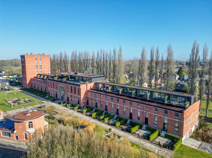 Dit penthouse met een ondergrondse parking en kelderberging bevindt zich in een karaktervol gebouw dat vroeger dienst deed als chocoladefabriek en met