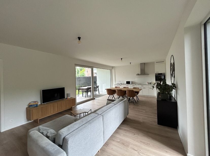 Modern gelijkvloers appartement te huur in Lommel.Indeling: inkomhal, toilet, woonkamer met open keuken, nachthal, berging/wasruimte, 2 slaapkamers, b