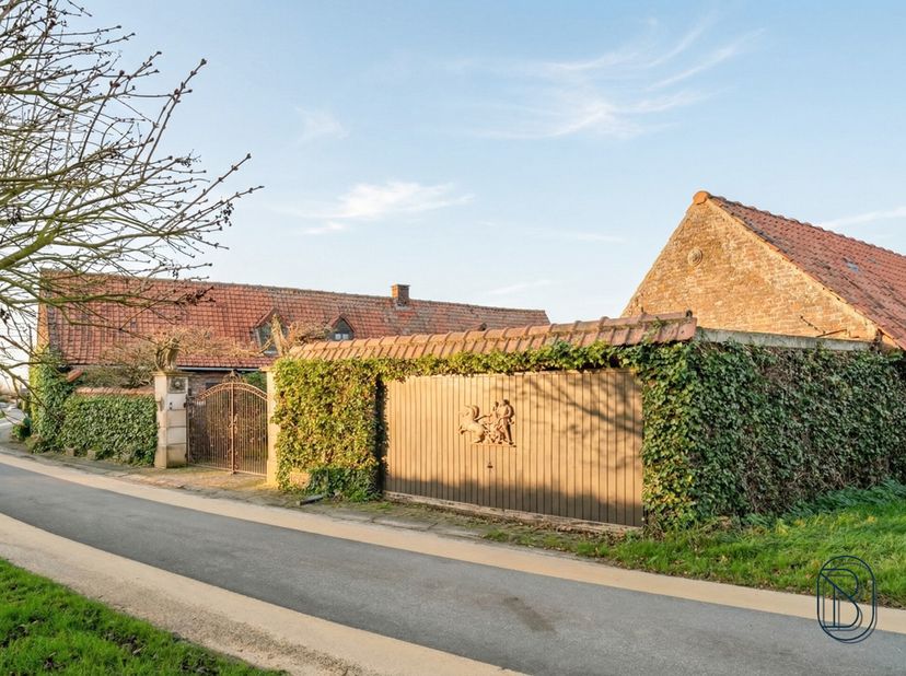 Ontdek deze op te frissen/ te renoveren charmante woning met prachtige authentieke elementen, een binnenkoer, dubbele garage en bijgebouwen op een rui