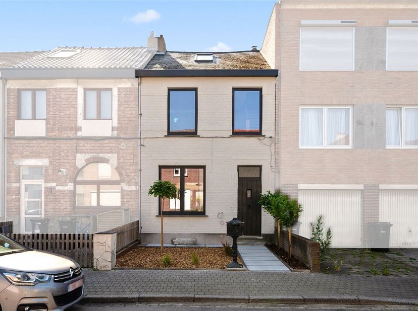 Deze woning met wit geschilderde gevel, ligt in een rustige éénrichtingsstraat (zone 30). Het gunstige EPC-label B, werd behaald door: achtergevelisol