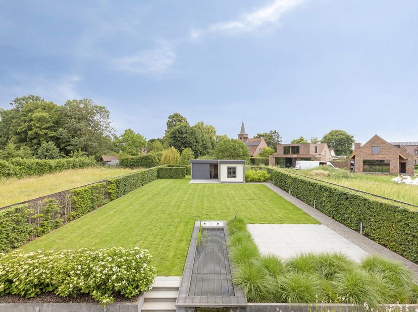 Het betreft hier een open bebouwing ingedeeld als volgt:<br />
GELIJKVLOERSE VERDIEPING<br />
Inkomhal: 8,5m² op tegelvloer, ruimte voor vestiaire en