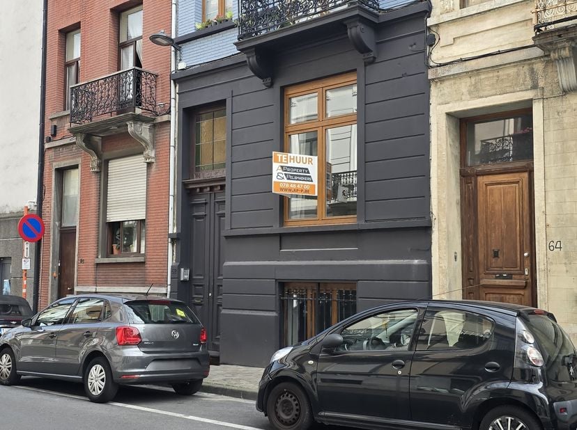On y entre par un hall d'entrée qui donne accès au spacieux salon-salle à manger. Grâce à ses hauts plafonds, ses parquets et ses cheminées d'époque,