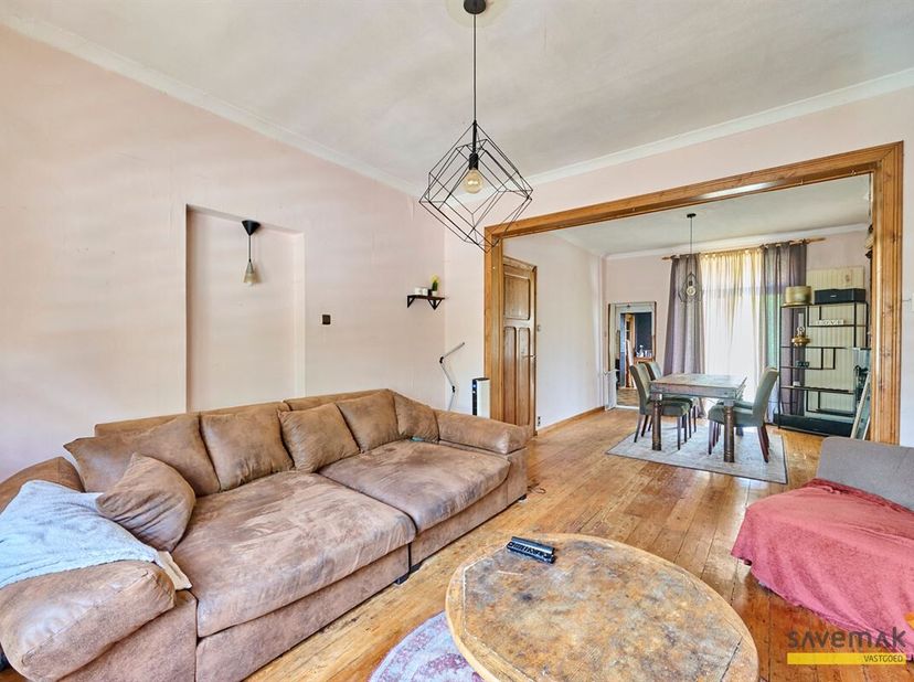 Op de benedenverdieping hebben we een woonkamer met originele layout en houten vloer, en die houten vloeren en accenten vinden we terug over heel de w