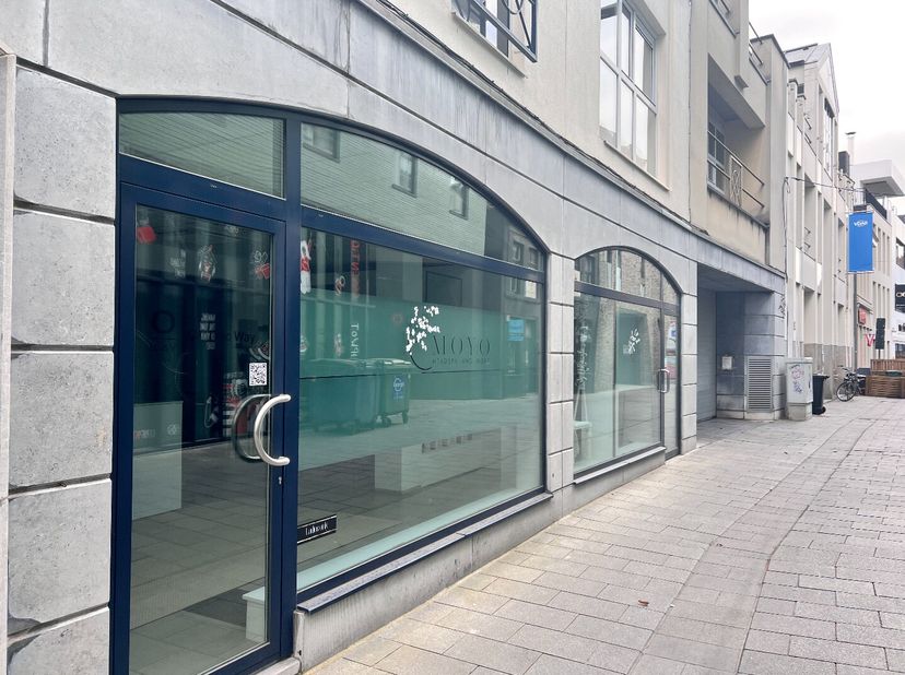 Dit multifunctioneel pand bevindt zich in een zijstraat van de Lange Steenstraat, dé bruisende winkelstraat van Kortrijk, en valt meteen op dankzij de
