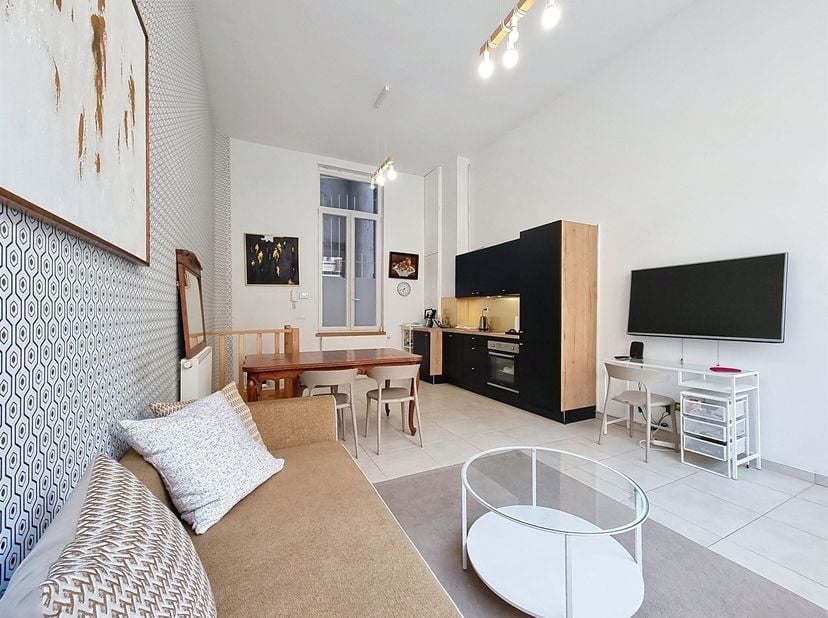 Wijk Saint-Gery – In een mooi appartementencomplex, prachtig gemeubileerd appartement van ca. 45 m², bestaande uit een hal, een mooie en lichte woonka