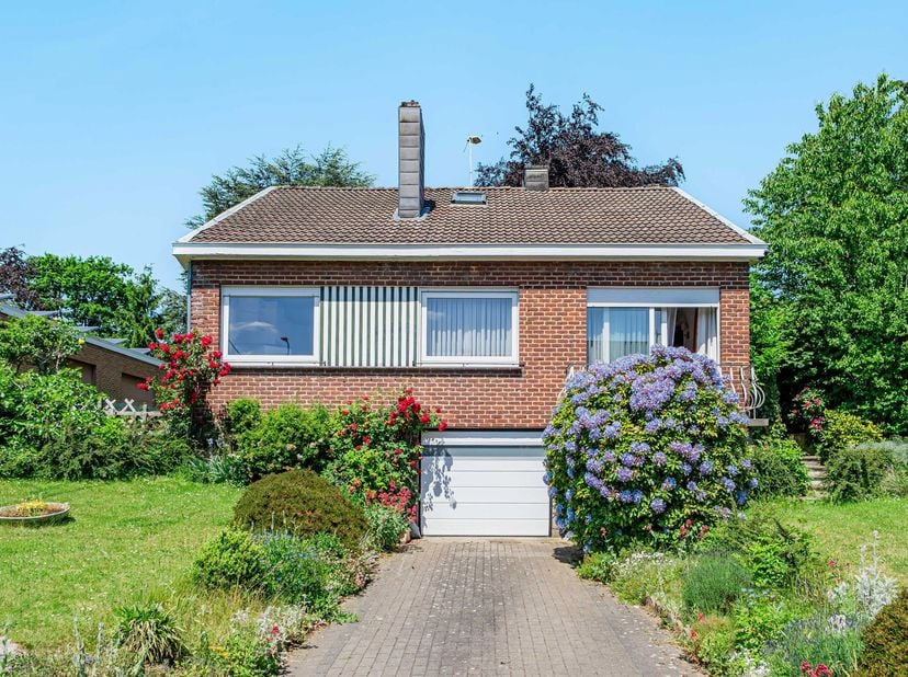 Spacieuse maison 4 façades, avec jardin et garage, offrant un beau potentiel de modernisation. Avec ses 4 à 5 chambres, dont une chambre et un bureau