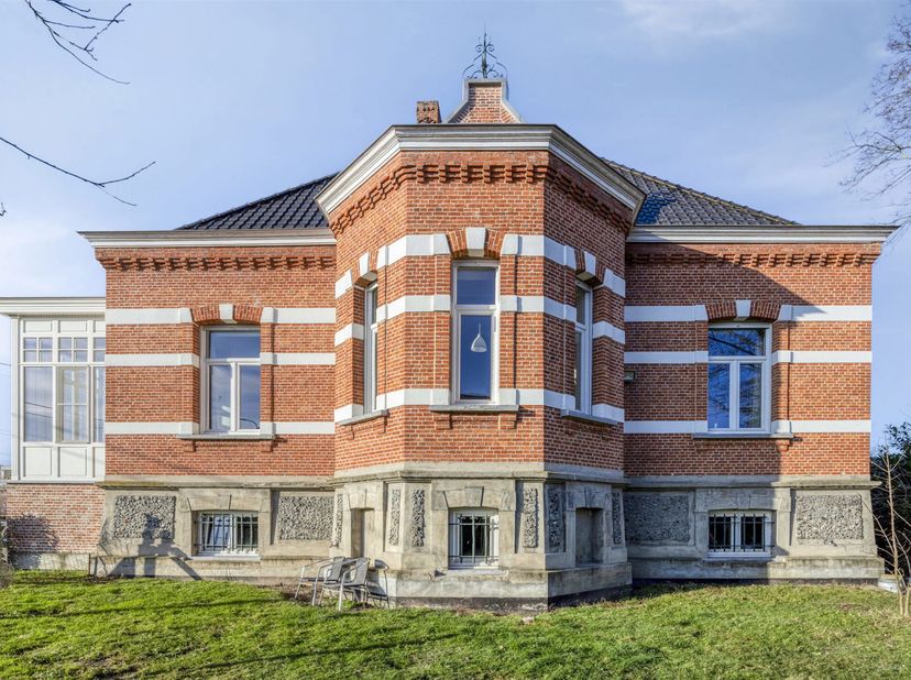Wij bieden u een indrukwekkend landhuis gelegen op een perceel van meer dan 17a maw mooi omgeven en genietende van een groene omgeving. Dit pand draag