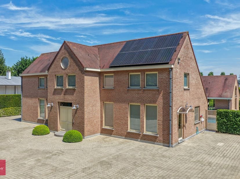 Inkomhal, living met open haard en afzonderlijk eetkamer, ingerichte keuken, bijkeuken, ruim bureel of slaapkamer op het gelijkvloers, badkamer, 3 sla