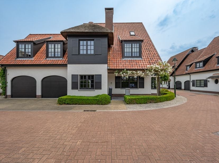Hedendaagse alleenstaande villa gelegen in een rustige omgeving te Knokke. Indeling: inkomhal met vestiaire en gastentoilet. Ruime lichtrijke woon- en