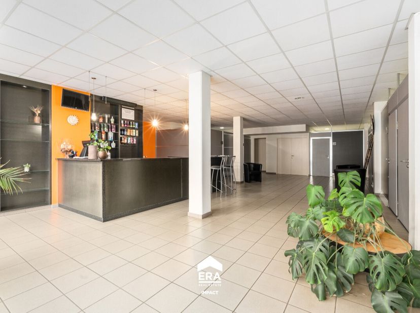 Dit ruim handelspand in Bree is uitstekend gelegen langs een drukke weg, waardoor het geniet van een constante stroom voorbijgangers en klanten. De ce