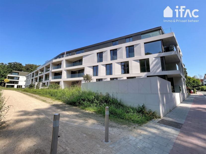 Ruime leefruimte van 47m² met een volledig uitgeruste open keuken en een toegang naar het prachtige terras (24m²) met zicht op de gemeenschappelijke t