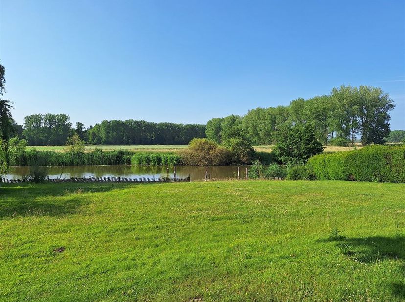 Cette charmante maison est située au bord de la rivière Lys. Avec une surface habitable de 159m² et un terrain généreux de 1325m², cette maison allie