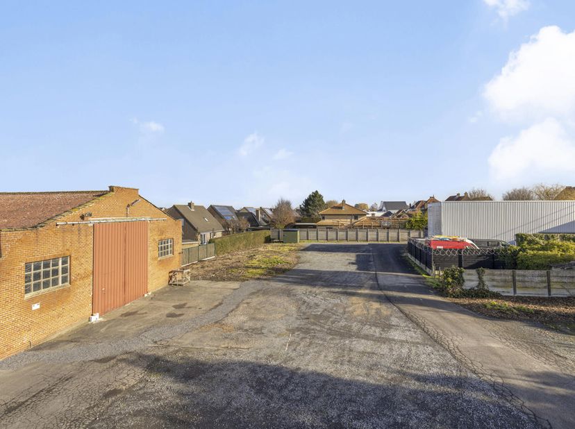Eigendom op 7.100m² bestaande uit een grote villa met voor en achtertuin met aanpalend 2 grote magazijnen en bijhorende parking. De villa bestaat uit