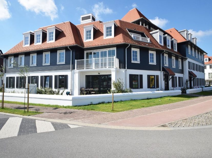 Lumineus en luxueus tuinappartement in een villaresidentie in Duinenwater. Inkomhal met vestiaire en toilet. Lumineuze leefruimte met keuken en woonka